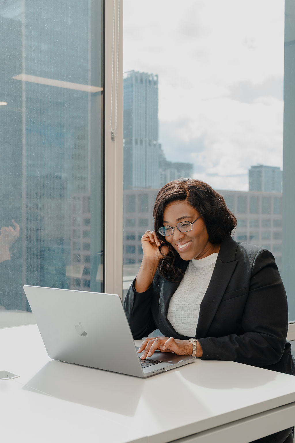 Esther Godwins working at her laptop